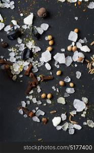 Spices and seeds with salt at black background. seasoning. Colorful natural additives.