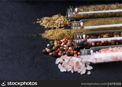 Spices assortment in glass tubes on stone table