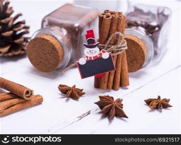spices cinnamon and star anise on white wooden background