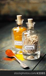 spices in bottles on rustic background