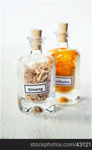 spices in bottles on rustic background