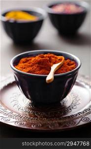 spices in bowls: curry pink and black pepper paprika powder