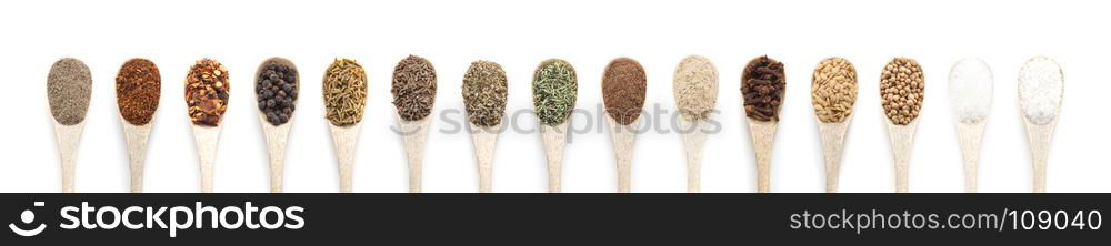 Spices in spoons isolated on white background. Top view.. Ground black Pepper spices in wooden spoon isolated on white bac