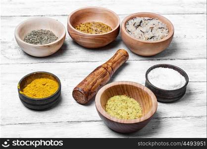 Spices in wooden bowl. Spices and seasoning to the dishes in wooden bowls