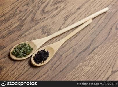 spices in wooden spoons on wooden table