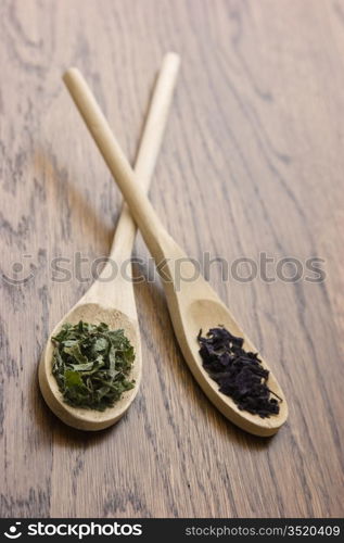 spices in wooden spoons on wooden table