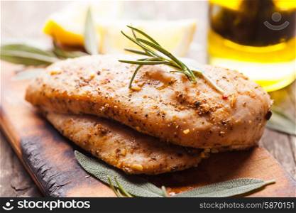Spicy baked chicken breast with rosemary close up. baked chicken breast