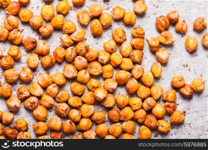 Spicy baked chickpeas scattered on baking paper. Spicy baked chickpeas