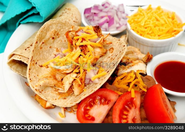 Spicy Chicken Tacos. Spicy white meat chicken taco with red onion, cheddar cheese, sliced tomatoes and a small bowl of red hot suace