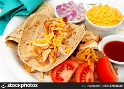 Spicy Chicken Tacos. Spicy white meat chicken taco with red onion, cheddar cheese, sliced tomatoes and a small bowl of red hot suace