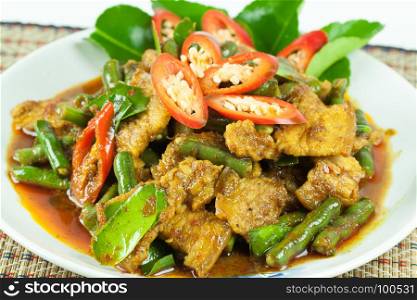 spicy fried pork with yardlong been on white plate