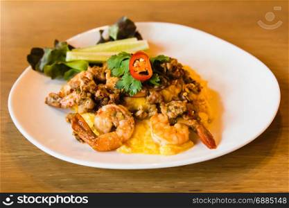 Spicy fried rice with shrimp and egg on white dish