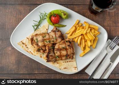 Spicy grilled chicken on a white porcelain plate
