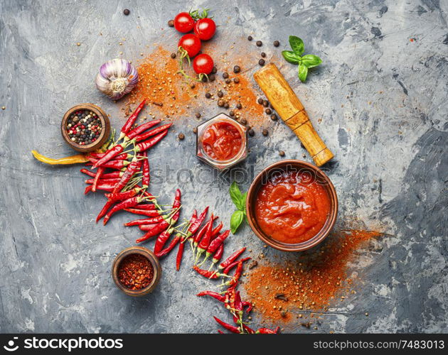 Spicy hot chili sauce with of chilli pepper. Red hot chilli sauce