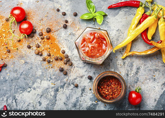 Spicy hot chili sauce with of chilli pepper. Red hot chilli sauce