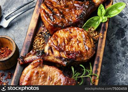 Spicy hot grilled spare ribs on wooden cutting board.Pork rack grilled. Fresh grilled meat