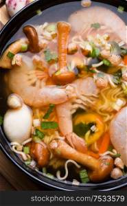 spicy instant noodles soup with shrimps and mushrooms. flat lay. close up