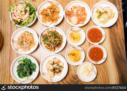 Spicy Kimchi group. Korean pickle or Pickled radish vegetables and seasoning on bowl on wood table background, Japanese food