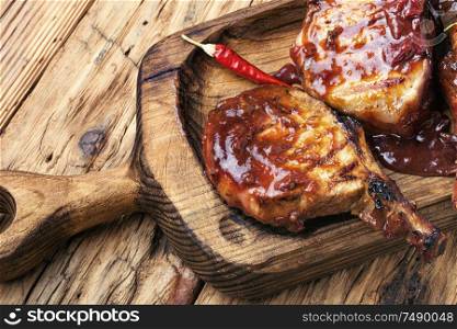Spicy meat grilled spare ribs on wooden cutting board. Fresh grilled meat