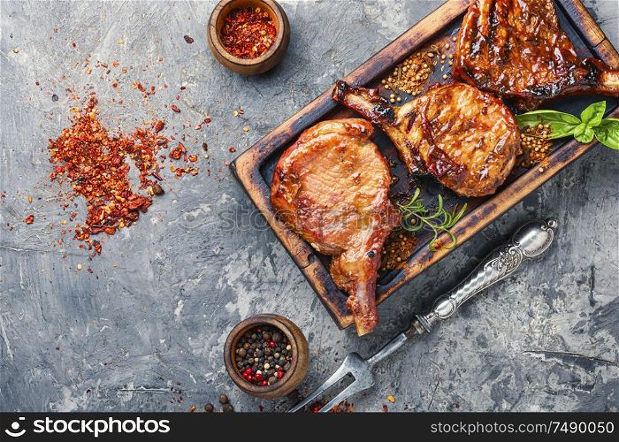 Spicy meat grilled spare ribs on wooden cutting board. Pork ribs grilled