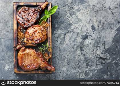 Spicy meat grilled spare ribs on wooden cutting board. Pork ribs grilled