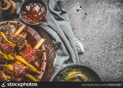 Spicy meat skewers with barbecue sauce on rustic kitchen table background, top view, place for text