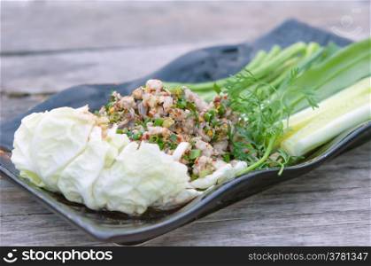 spicy minced pork . spicy minced pork eaten with fresh vegetable on plate