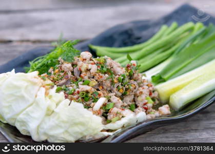 spicy minced pork . spicy minced pork eaten with fresh vegetable on plate