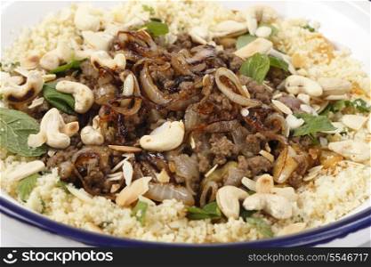 Spicy Moroccan style minced beef served with couscous mixed with chopped herbs and dried apricots, garnished with toasted cashew nuts and almond slivers and topped off with fried onions.