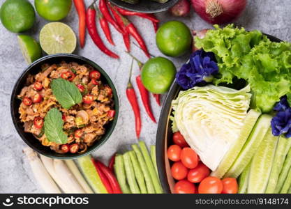 Spicy pork chops in a black cup consisting of lemons Chili and side dishes. Selective focus