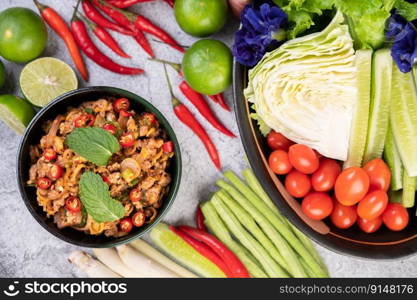 Spicy pork chops in a black cup consisting of lemons Chili and side dishes. Selective focus