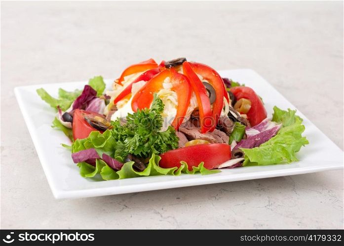 spicy salad of roast beef with potato, tomato, cabbage, pepper and lettuce