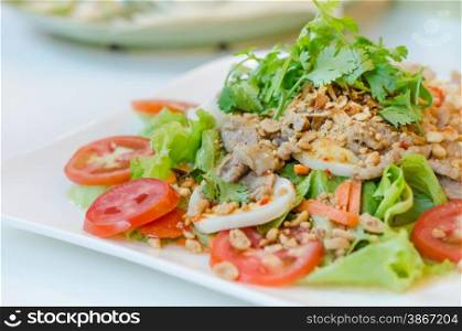 spicy salad with egg , pork and fresh vegetable