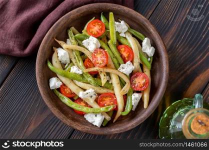 Spicy salad with green and yellow beans, tomatoes and feta cheese