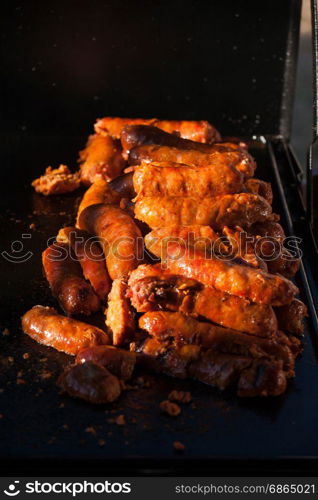 Spicy sausages on the plate ready to be eaten. Grilling sausages on grill