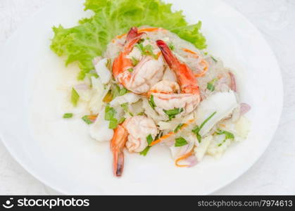 spicy seafood salad. spicy noodle salad with seafood on white dish