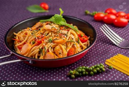 Spicy Spaghetti in a Pan With tomatoes Spaghetti and Forks.
