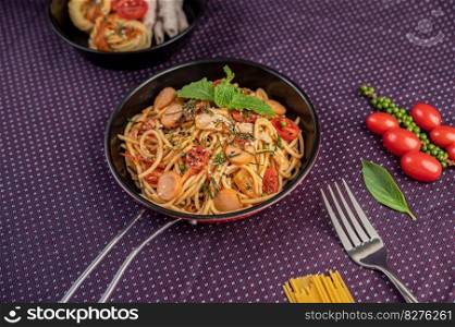 Spicy Spaghetti in a Pan With tomatoes Spaghetti and Forks.