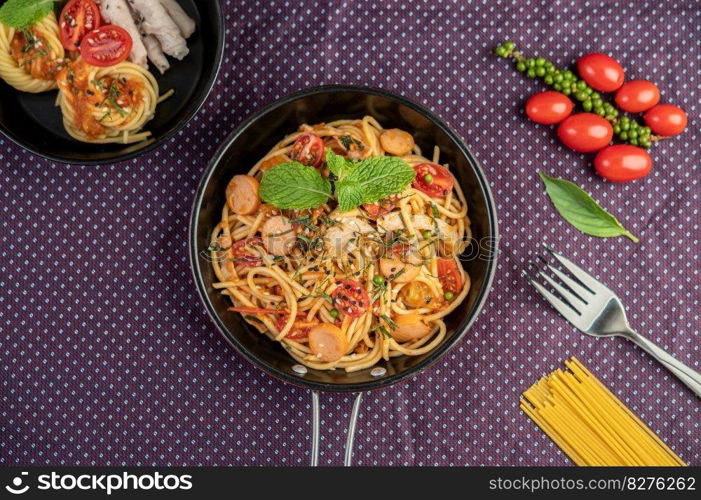 Spicy Spaghetti in a Pan With tomatoes Spaghetti and Forks.