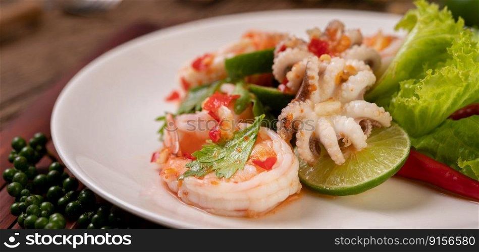 Spicy Squid and Shrimp Salad in White Dish with Lemon Cilantro and lettuce.
