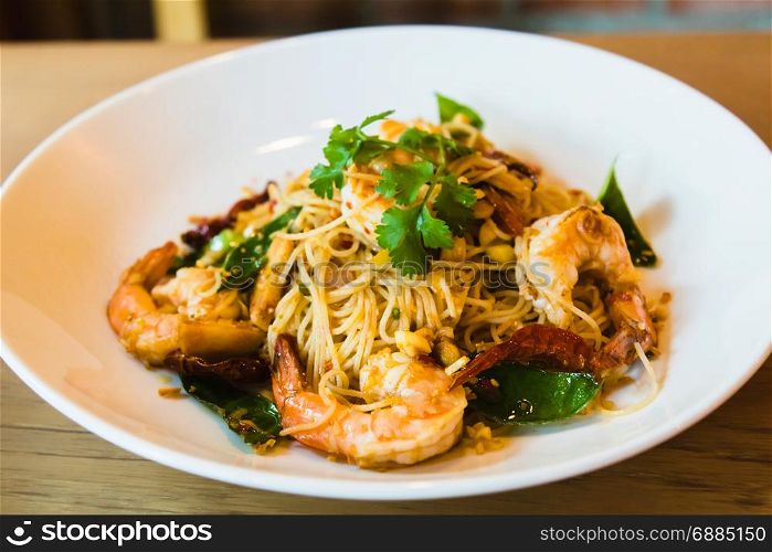 Spicy stir fried spaghetti seafood on white dish