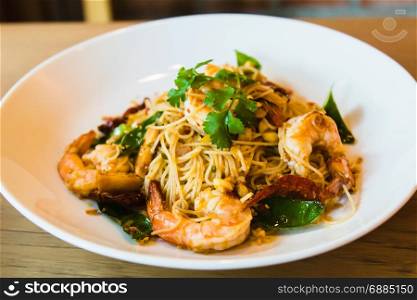 Spicy stir fried spaghetti seafood on white dish