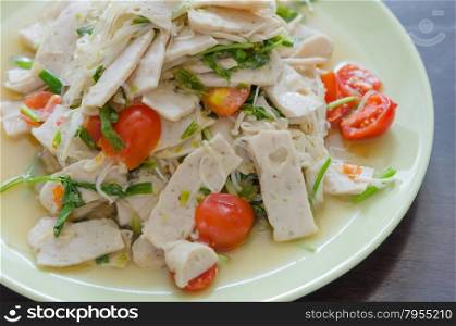 Spicy white pork sausage salad, Thai food on green dish