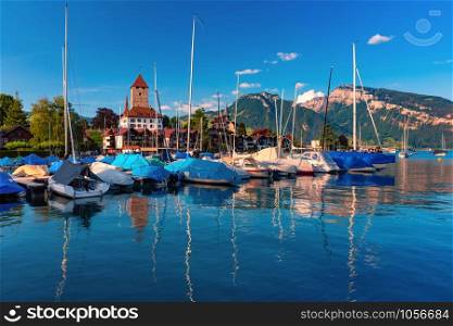 Spiez Church and Castle on the shore of Lake Thun with yachts on the Swiss canton of Bern at sunset, Spiez, Switzerland.. Spiez Church and Castle, Switzerland