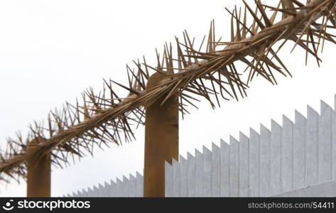 Spiked fence, rusty old an shiny new spikes