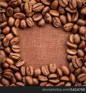 Spilled coffee beans frame over linen textile
