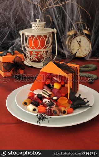 Spilled out of the box sweets on the holiday table in honor of Halloween