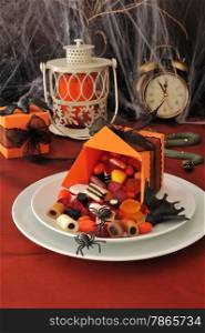 Spilled out of the box sweets on the holiday table in honor of Halloween