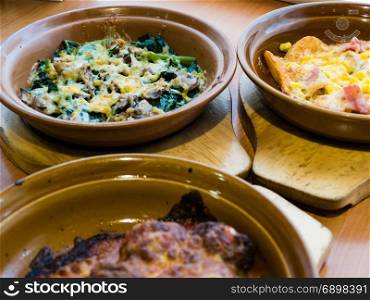 Spinach and mushroom in melted cheese; meatballs in sauce; potato wedges with bacon
