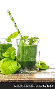 Spinach leaves smoothie in transparent glass. Healthy green drink. Vegetarian nutrition